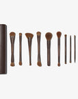 A set of 11, mostly dual-ended makeup brushes with brown handles and hypoallergenic synthetic bristles, displayed alongside a brown vegan magnetic brush clutch.