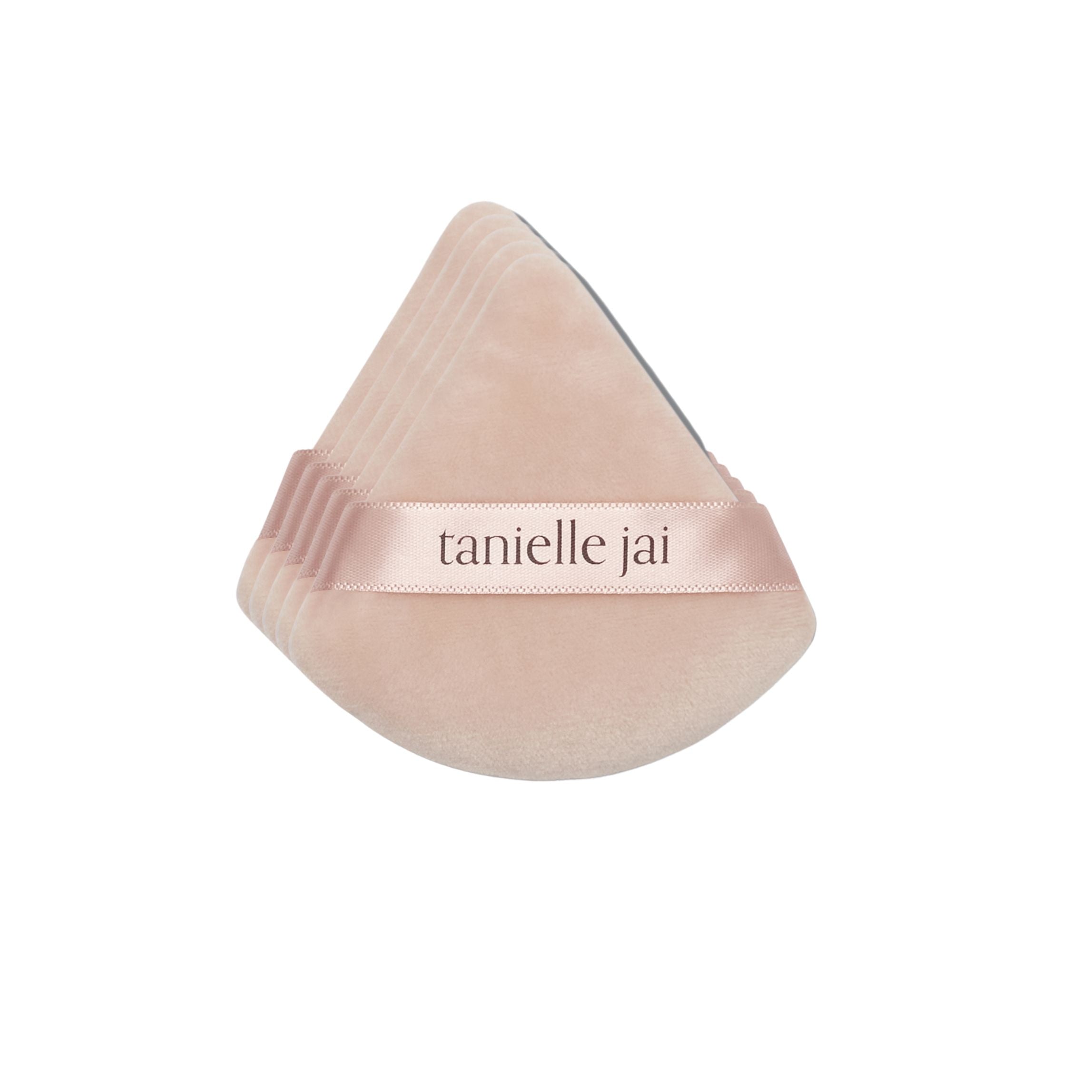 A pack of 5 triangular pink velvet powder puffs with the logo 'tanielle jai' featured across the center.
