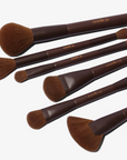 A set of 11, mostly dual-ended makeup brushes with brown handles and hypoallergenic synthetic bristles, displayed alongside a brown vegan magnetic brush clutch.