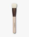Back view of the 1.Base brush with a beige handle and white bristles, with the logo 'Tanielle Jai' inscribed on the handle, and a copper ferrule connecting the handle to the bristles.