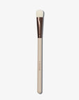 A Concealer brush with a flat, fluffy tip and a beige handle with a copper ferrule.